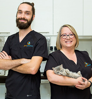 Two Proanima employees, one holding a cat